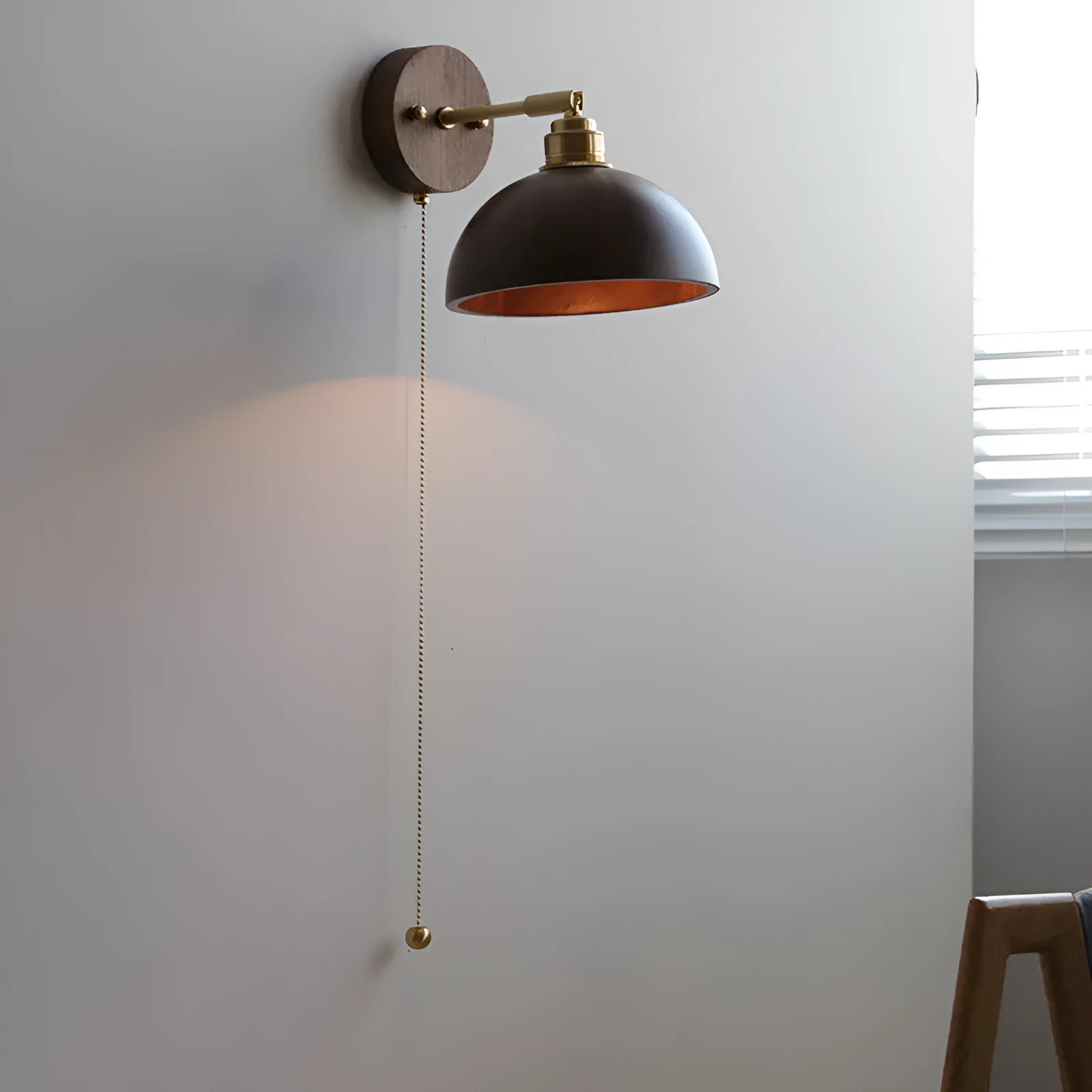 Nordic style wooden bedside wall lamp in walnut colour mounted on a wall.