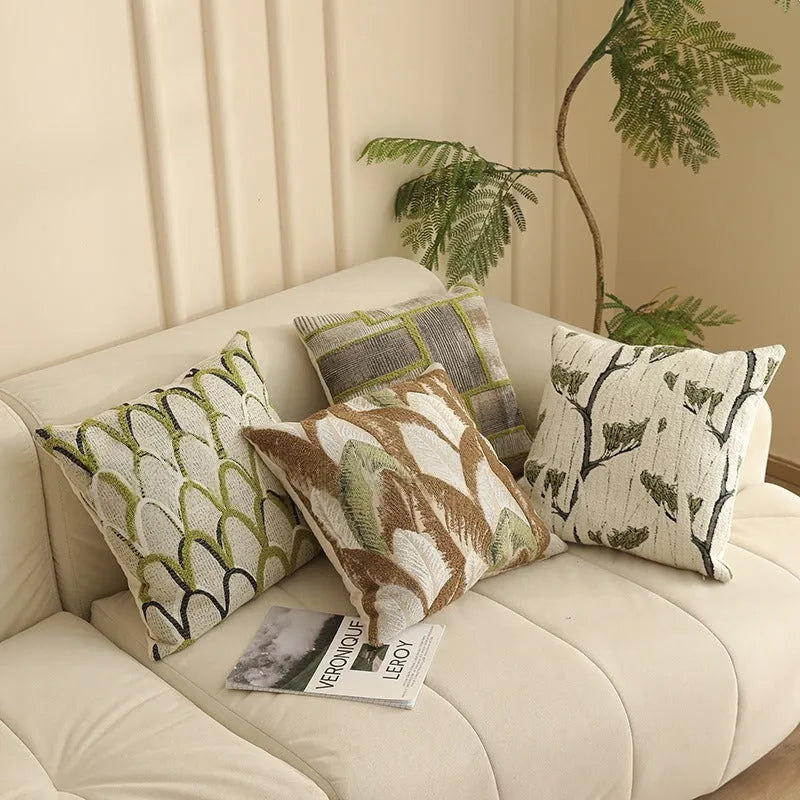 Square jacquard pillow with botanical floral pattern, shown in one of eight available colour options.