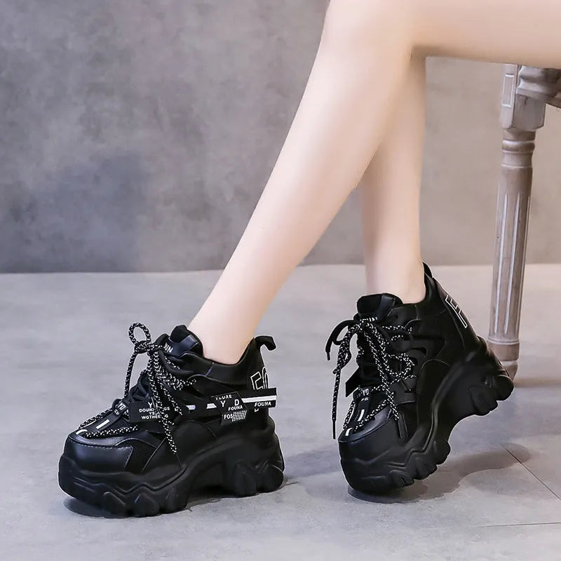 White women's mesh platform sports shoes with cross-strap detail and rubber sole.
