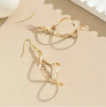 Gold spiral geometric earrings with ellipse diamond-style ornament for women