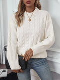 Women's loose beige round neck casual sweater with textured thread detail on a hanger.