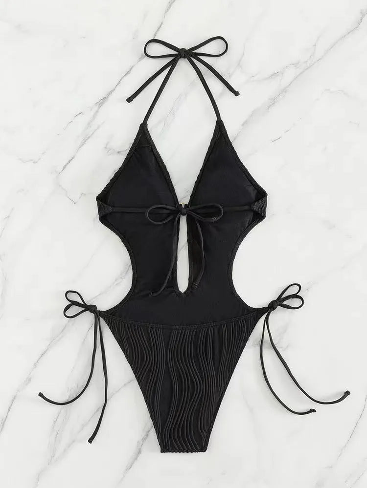 Women's black lace-up triangle bikini swimsuit on a mannequin, front view.