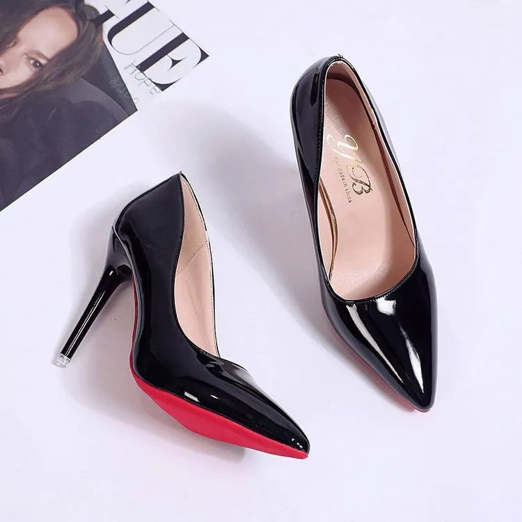 Women's black pointed toe stiletto pump with a shallow mouth design on a rubber sole.