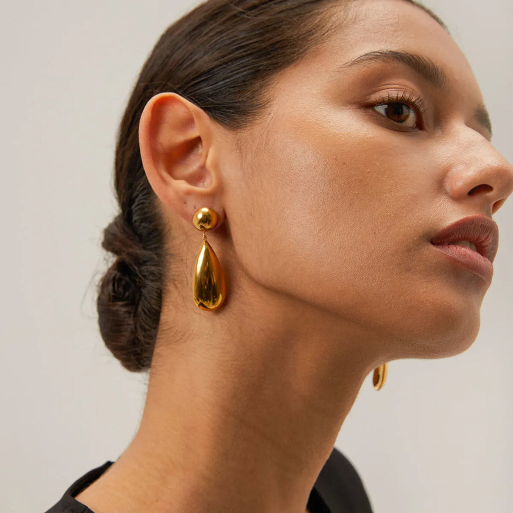 Gold-coloured stainless steel earrings with hemisphere and water drop pendant design