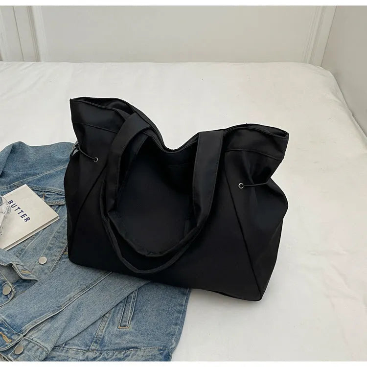 Soft Oxford cloth foldable tote bag shown in one of five colours: black, brown, dark grey, light grey, or purple.