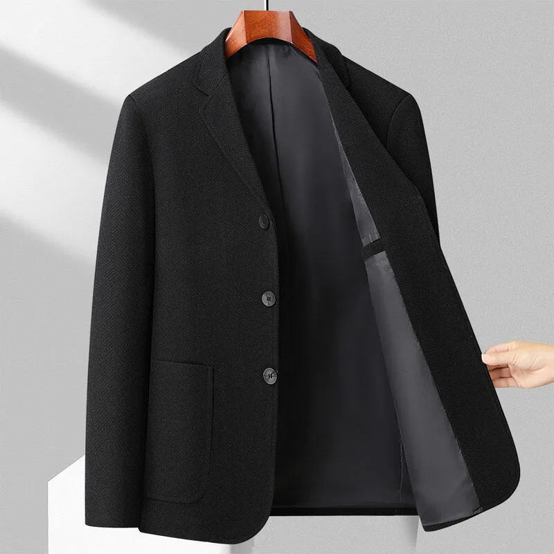 Man wearing a loose fit black woolen coat for casual spring or autumn leisure wear.