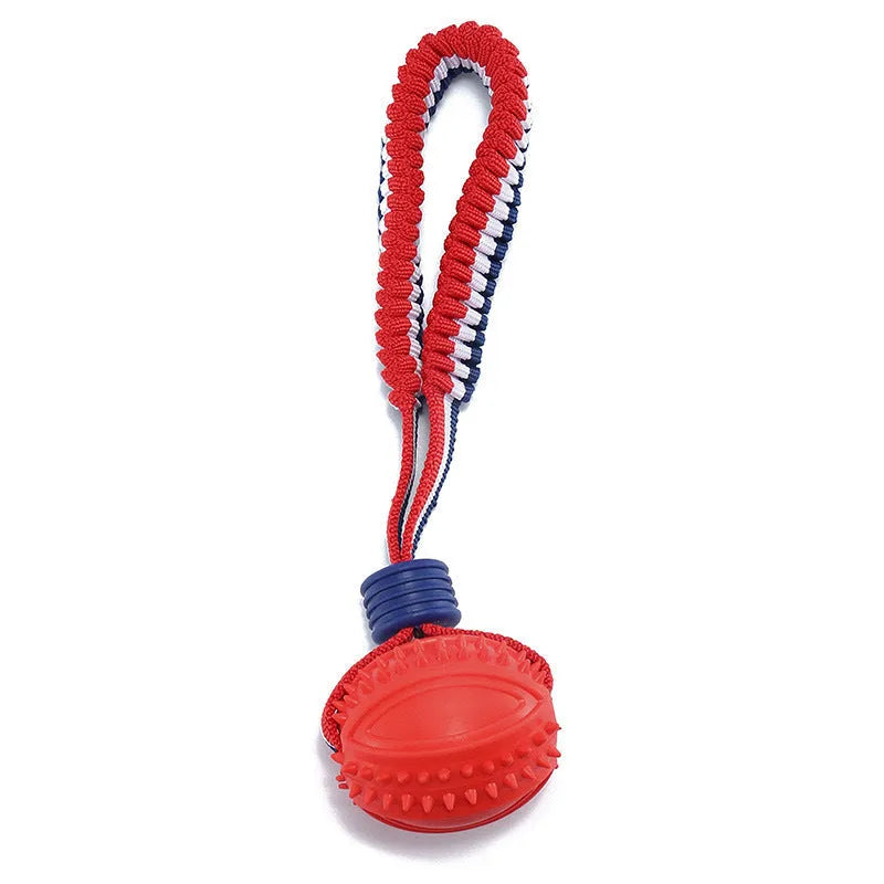 Red rubber dog ball with rope attachment for tug of war and teeth cleaning