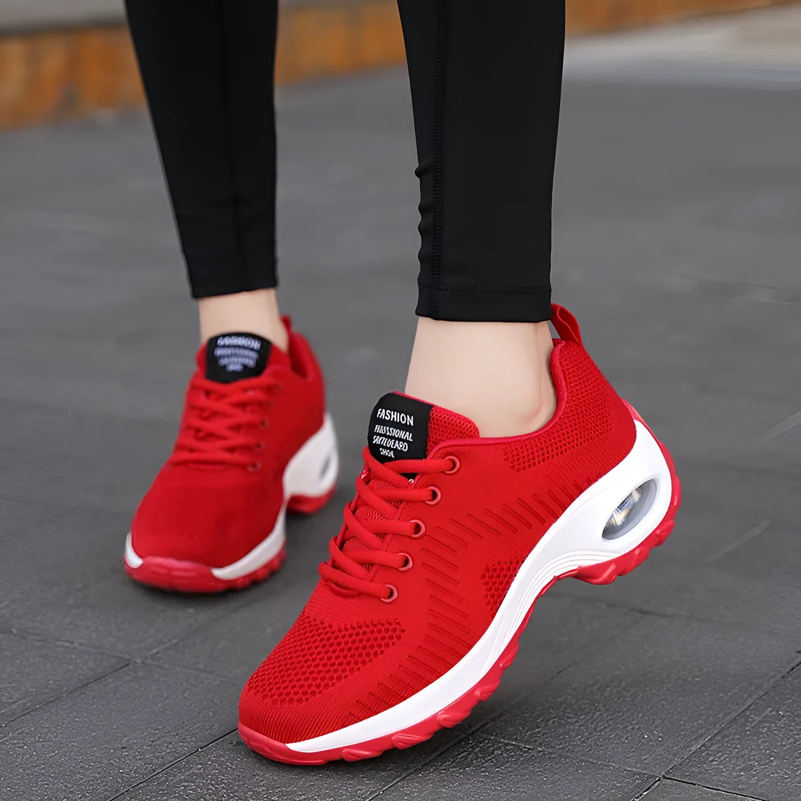 Women's black mesh sneakers with lace-up front and round toe, showing mid-heel height