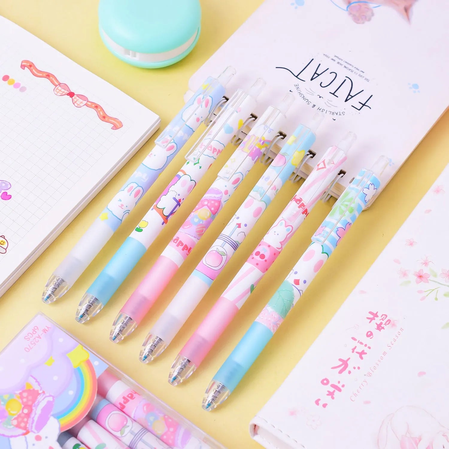 Six Cartoon Bunny brand black plastic pens with 0.5mm tips laid out from their box.