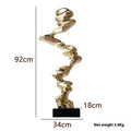 Modern abstract still life ornament in natural resin, shown in bright gold, elegant silver, and phantom blue finishes.
