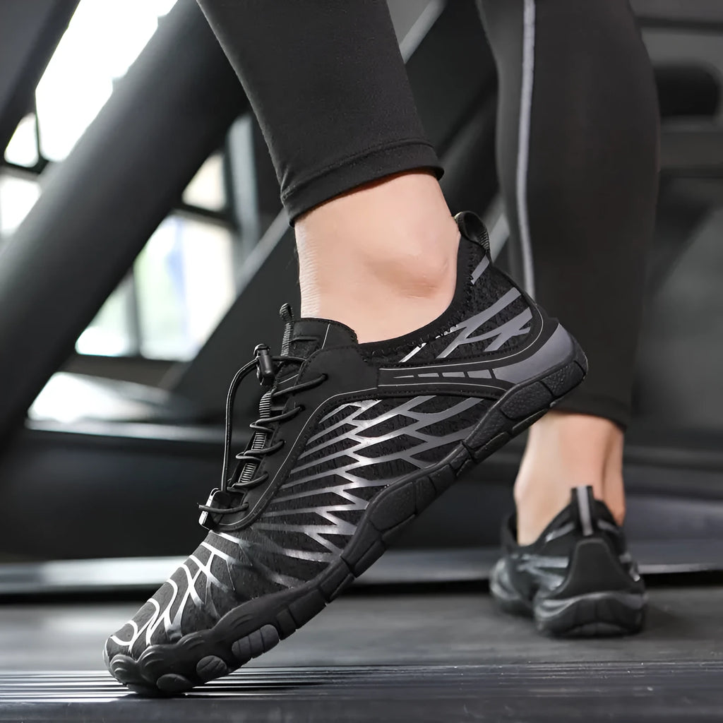 White and pink lace-up sports shoes with rubber sole on a plain background