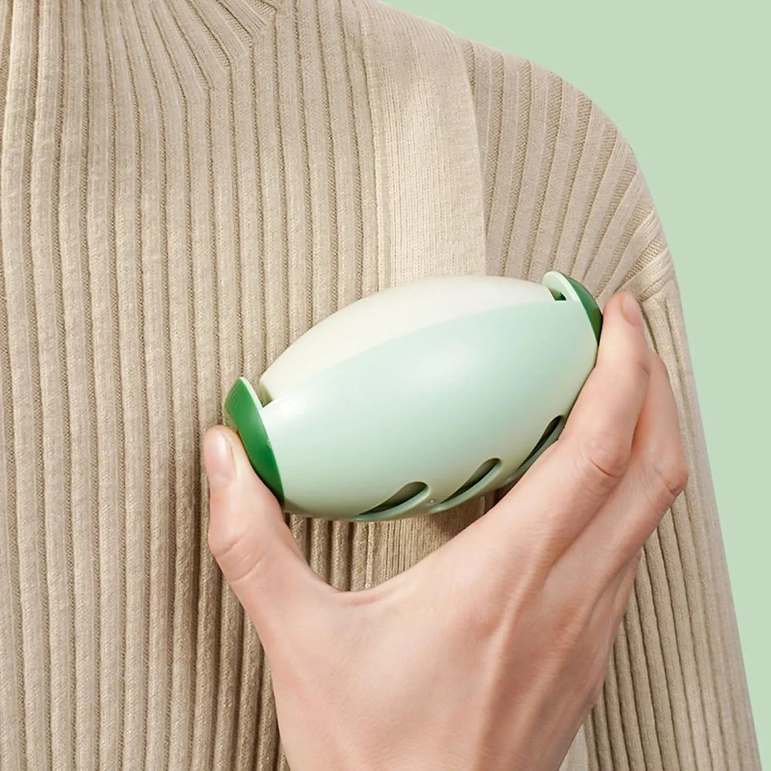 Green and white washable reusable gel lint roller ball for pet hair removal from clothes and furniture