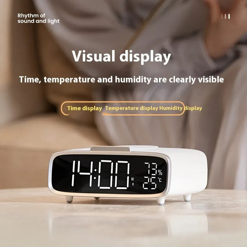 White Bluetooth speaker with wireless charging pad and integrated night lamp