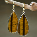 Vintage long water drop earrings in Tigereye stone, showing handmade retro design.