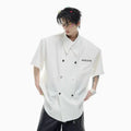 Men's loose casual short-sleeved shirt in black with spliced design and metal button decoration