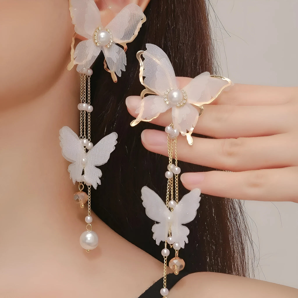 White butterfly earrings with tassel lace, pearl and rhinestone decoration on copper alloy