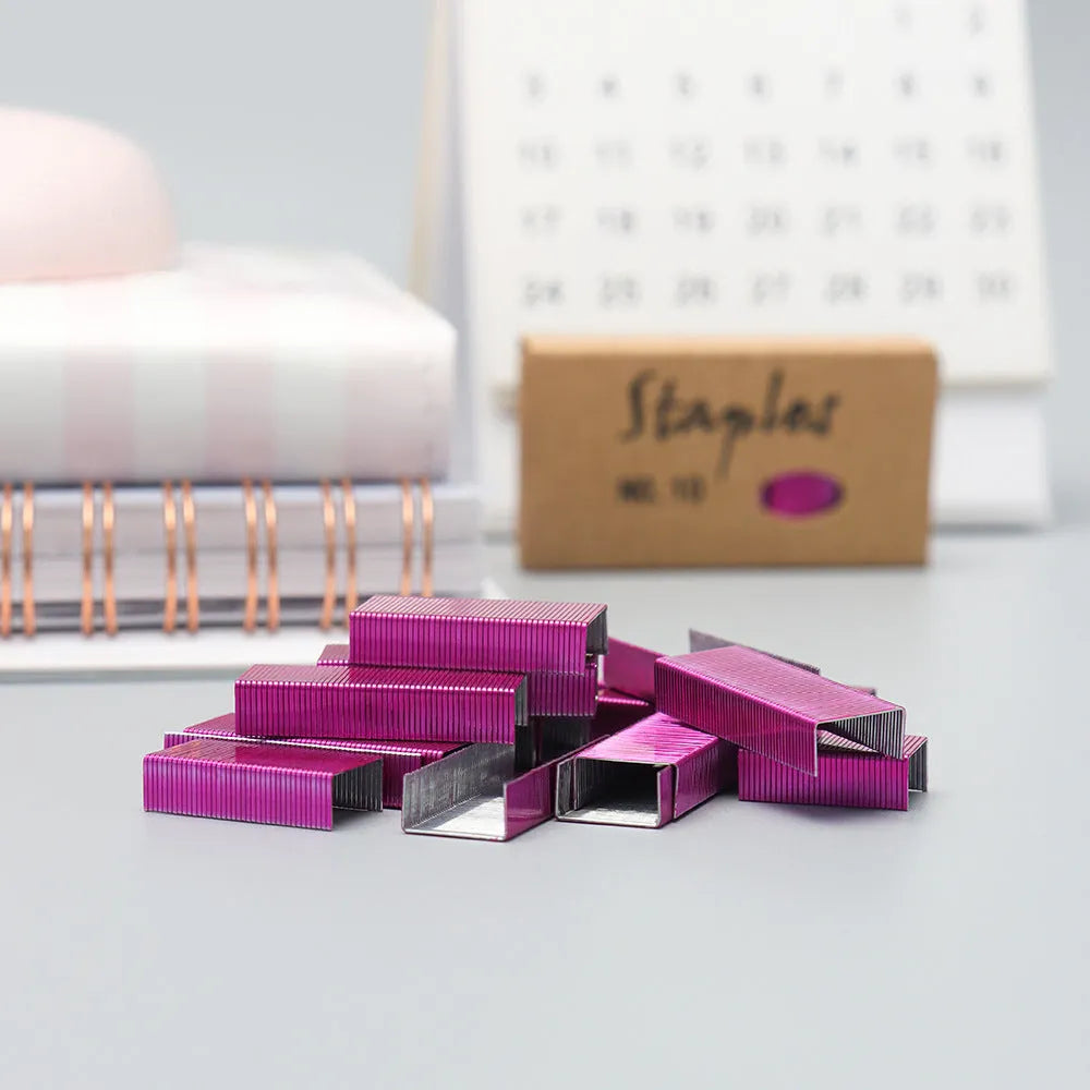 Box of 1000 metal office staples in rose gold, black, purple, and rose red finishes