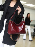 Genuine leather creative large capacity hand and shoulder commuter bag in caramel colour with pillow shape and patchwork details