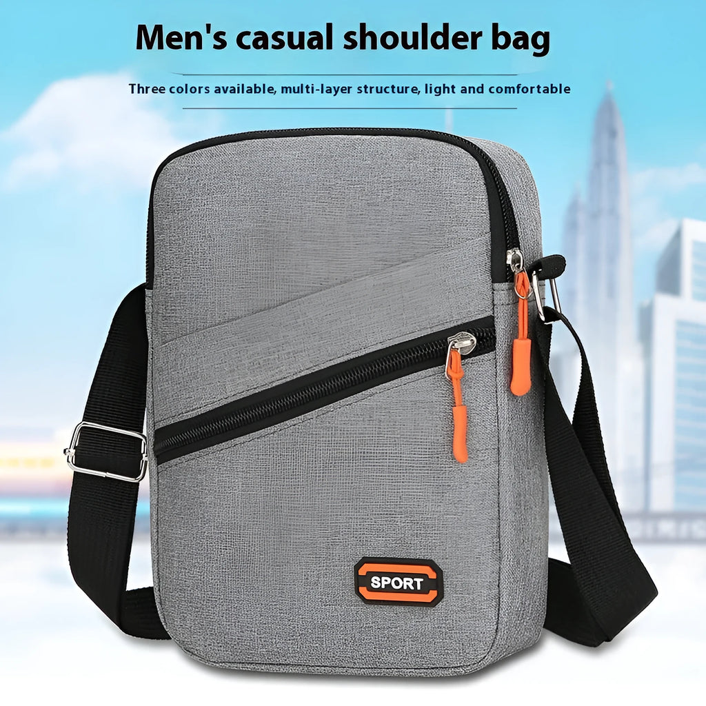 Lightweight solid colour oxford cloth crossbody commuter bag in black, navy, or silver grey.