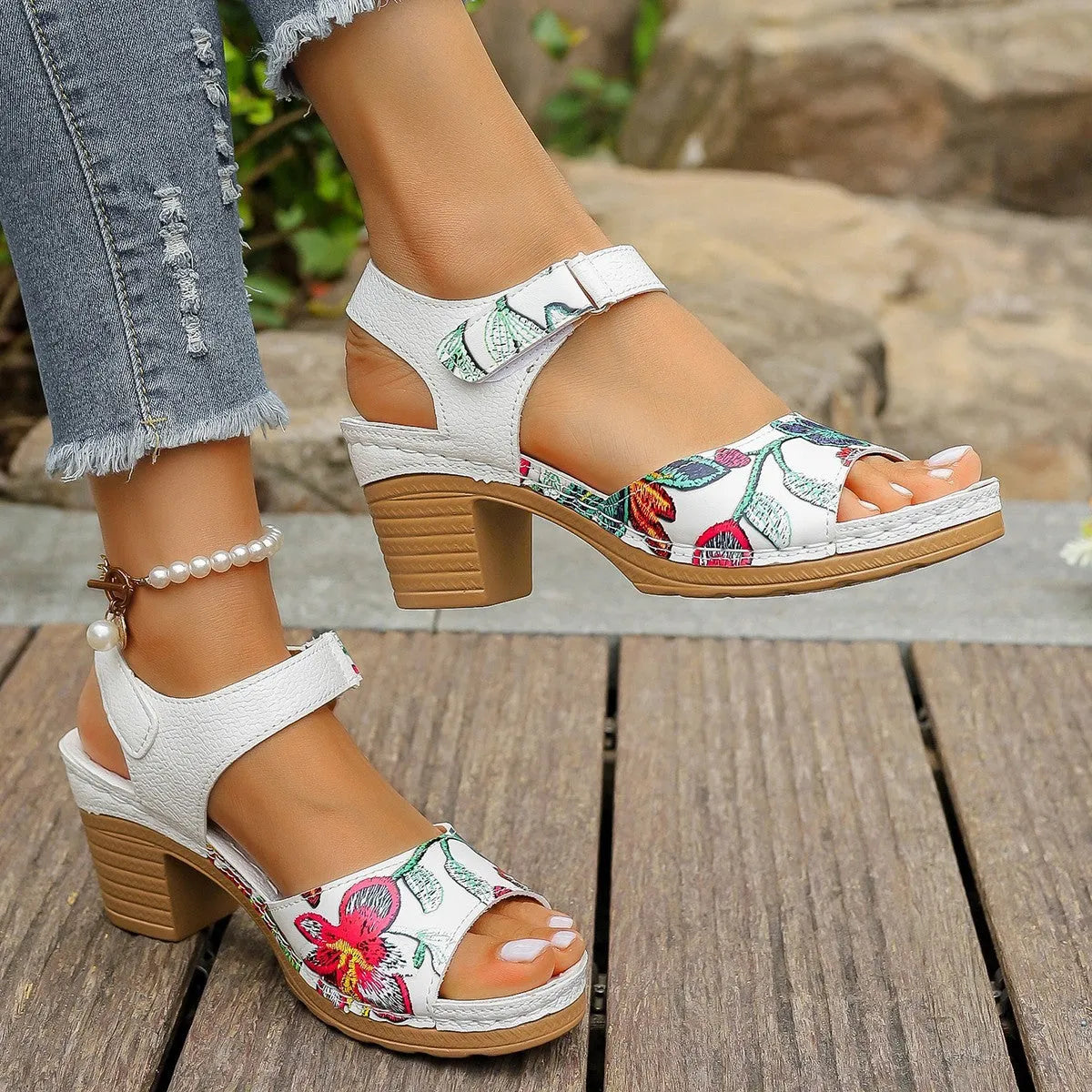 White women's high heel sandals with a Velcro strap fastener on a casual rubber sole.