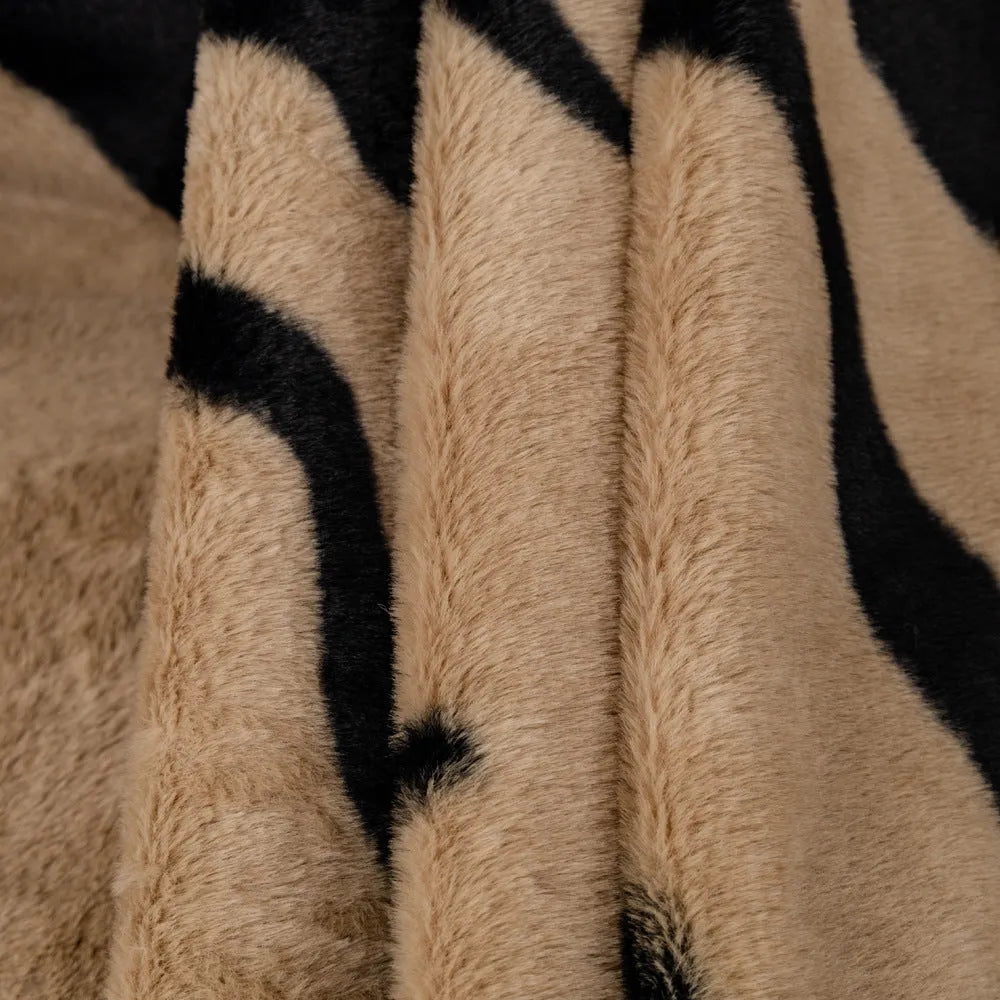 Zebra pattern flannel sofa cover with non-slip properties in caramel colour on a sofa