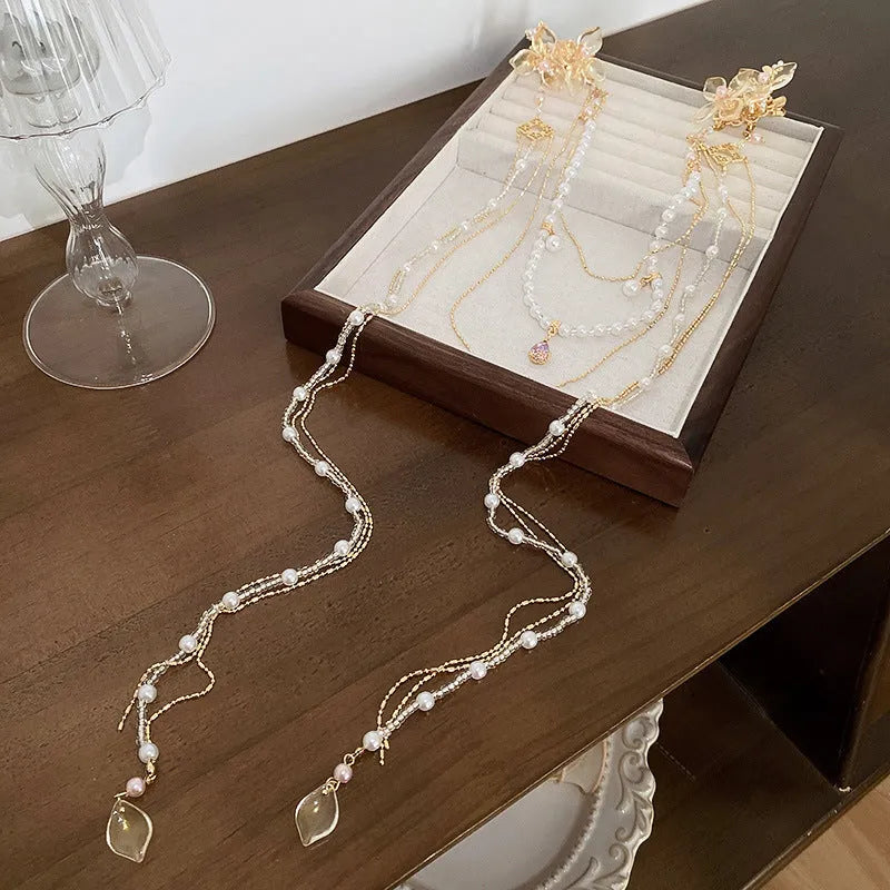 Gold women's hairpin with diamond flower design and long acrylic tassels