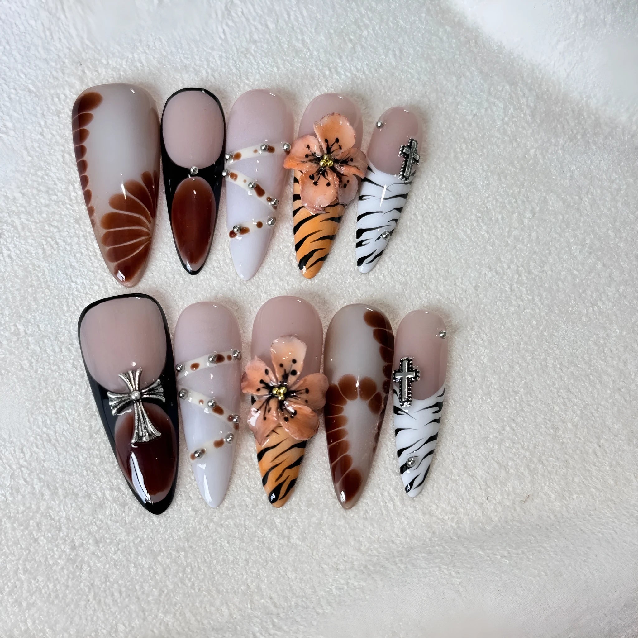 Handmade French style gel nail art stickers with leopard, cross and floral prints in four sizes.