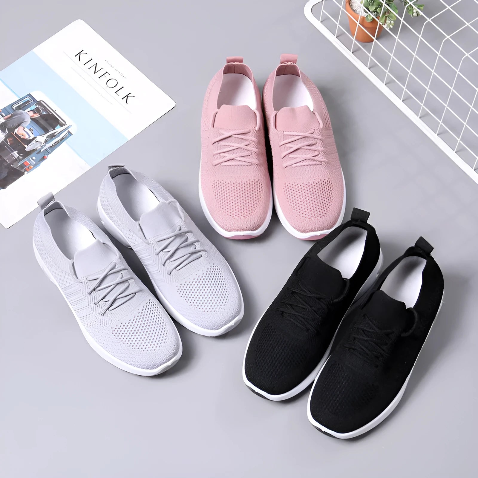 Women's grey lace-up sneakers with mesh upper and soft PVC sole on a light background.