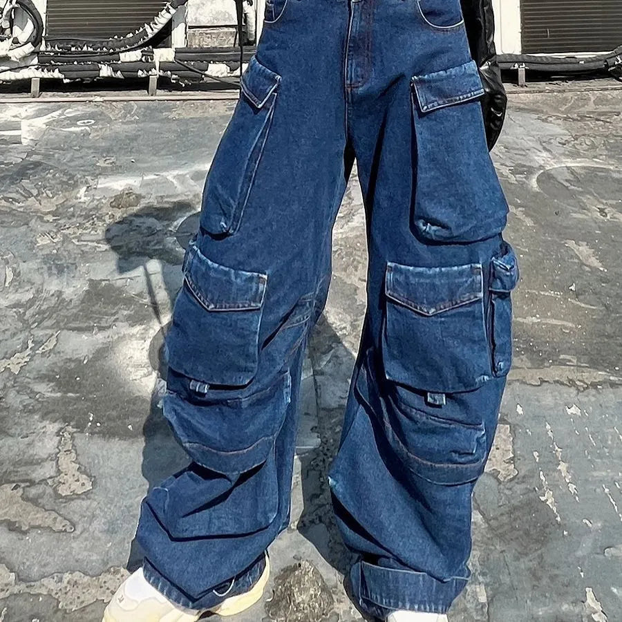 Dark blue distressed wide-leg jeans with high waist, multiple pockets, and raw hem detail