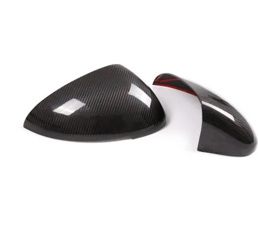 Genuine carbon fibre rearview mirror covers for a Porsche Macan, showing glossy black weave texture.