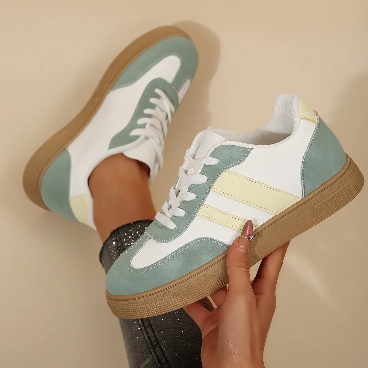 Green women's retro sports shoes with white cross straps and a low flat heel