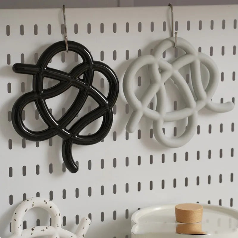 Ceramic heat proof mat in irregular shape with hook for hanging storage