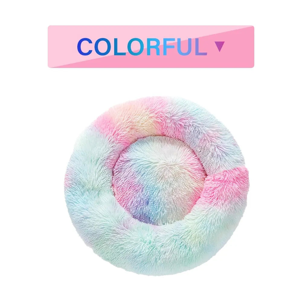 A round donut-shaped dog bed with a raised plush rim, shown in a light grey colour.