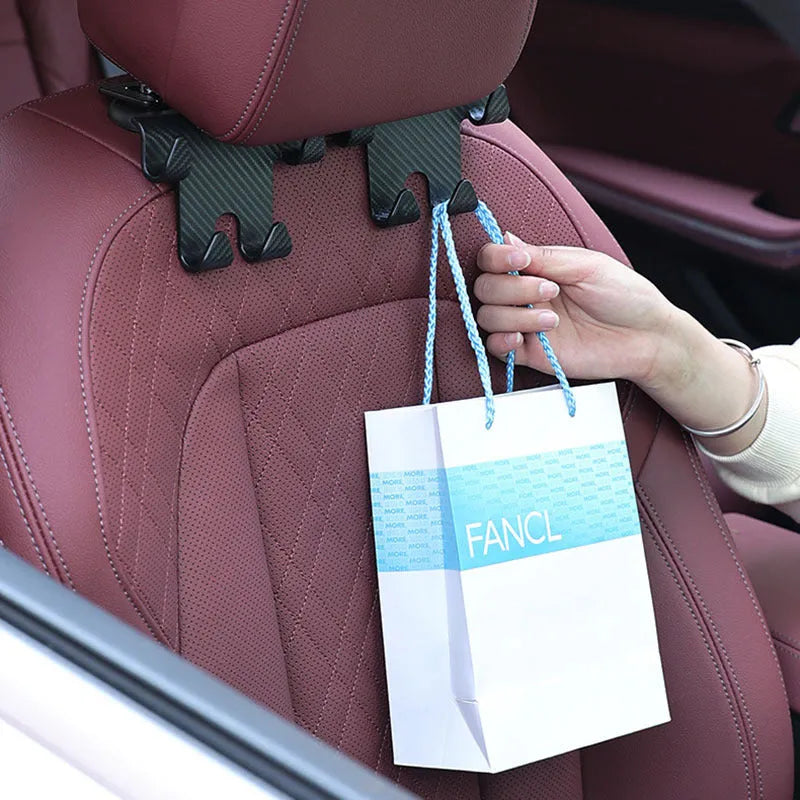 Black ABS plastic car hook with integrated mobile phone holder bracket for rear seat back.