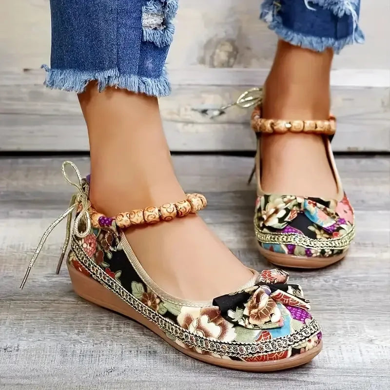 Women's black plus size ethnic platform sandals with cloth upper and elastic band.