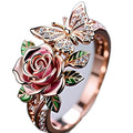 Adjustable alloy butterfly ring with oil-drip colour finish showing floral and insect details