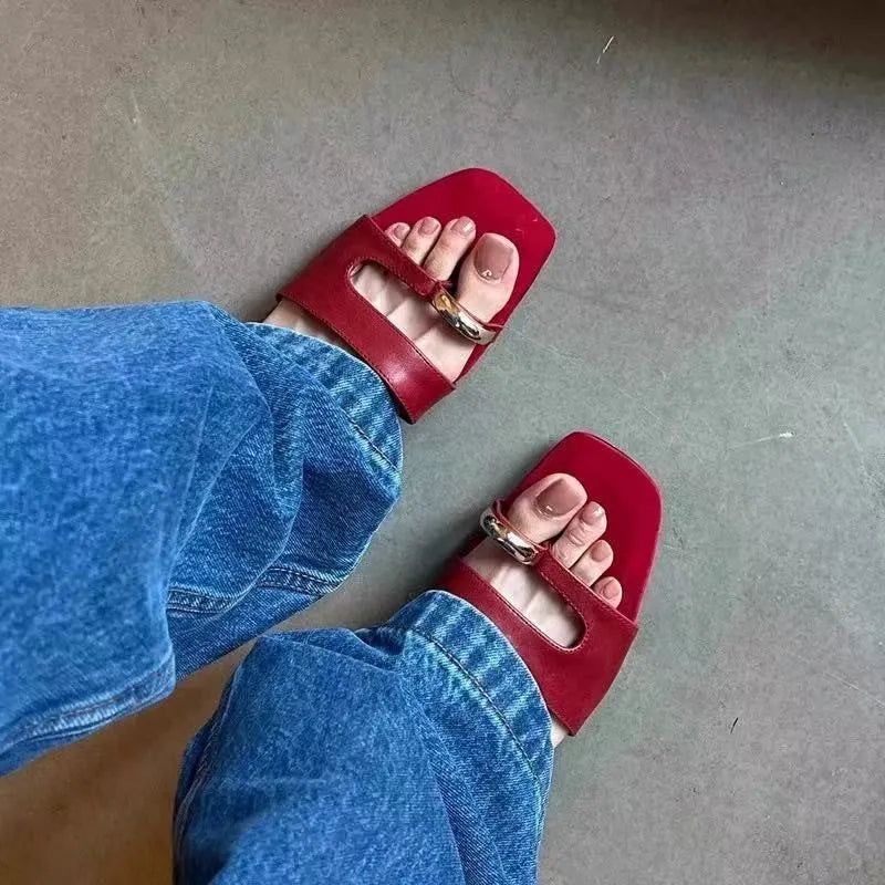 Square toe leather outdoor slipper in multiple colours on a plain background.