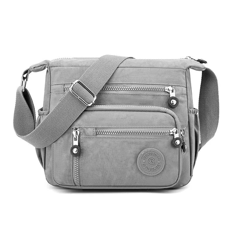 Grey soft nylon messenger bag with single shoulder strap showing square vertical shape