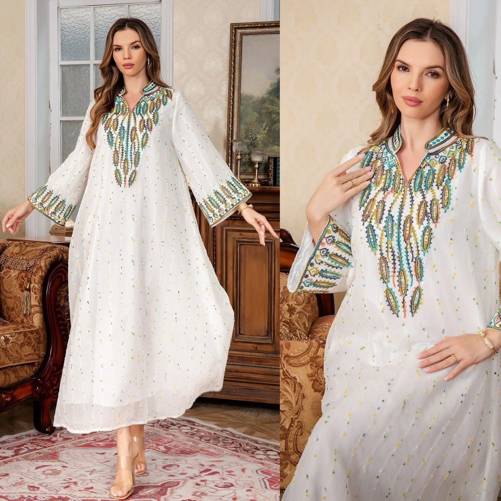 White women's Dubai Arabic robe with long sleeves and floor-length skirt.