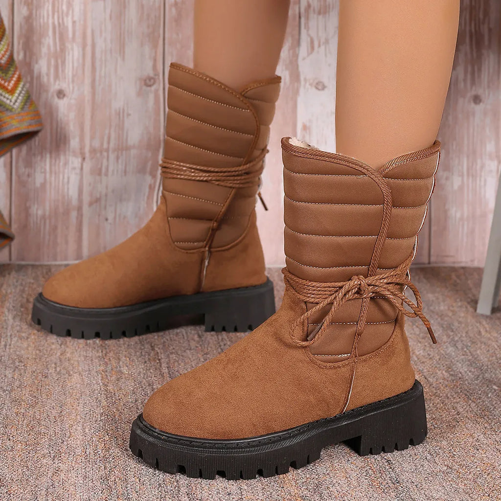 Women's black suede snow boots with chunky heel, lace-up front, and fleece lining.
