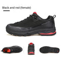 Men's low-top hiking boots in black with leather mesh upper and rubber outsole on a rocky path.