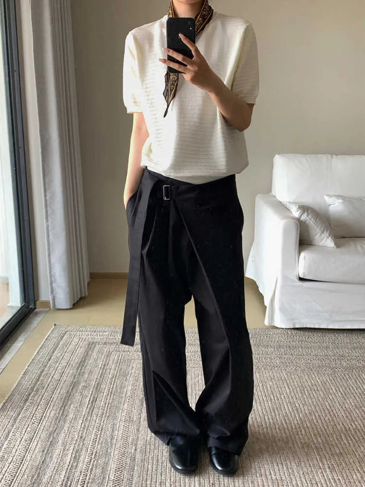 Black loose-fit straight-leg trousers with a single pleat and adjustable mid waist on a hanger.