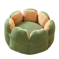 Grey petal-shaped plush kennel bed for cats and dogs on a hardwood floor.