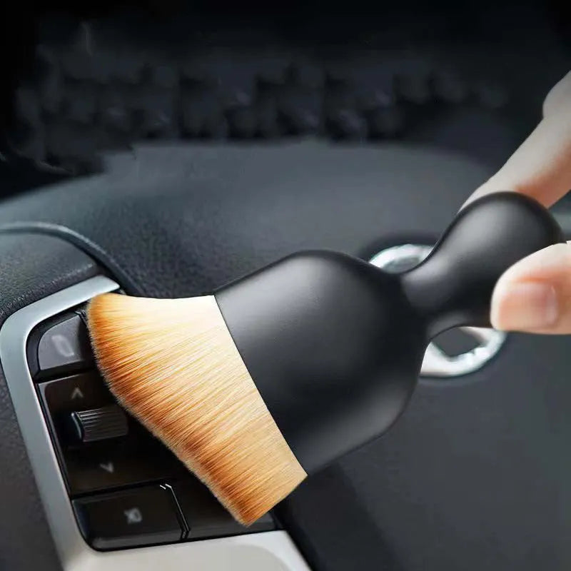 Soft PVC car interior cleaning brush for dust removal on dashboard and seats.