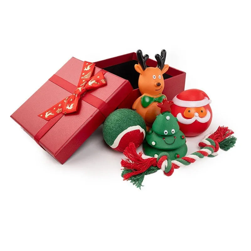 Christmas-themed vinyl dog toys including bite ropes, tennis balls, Santa heads, and deer figures in gift packaging