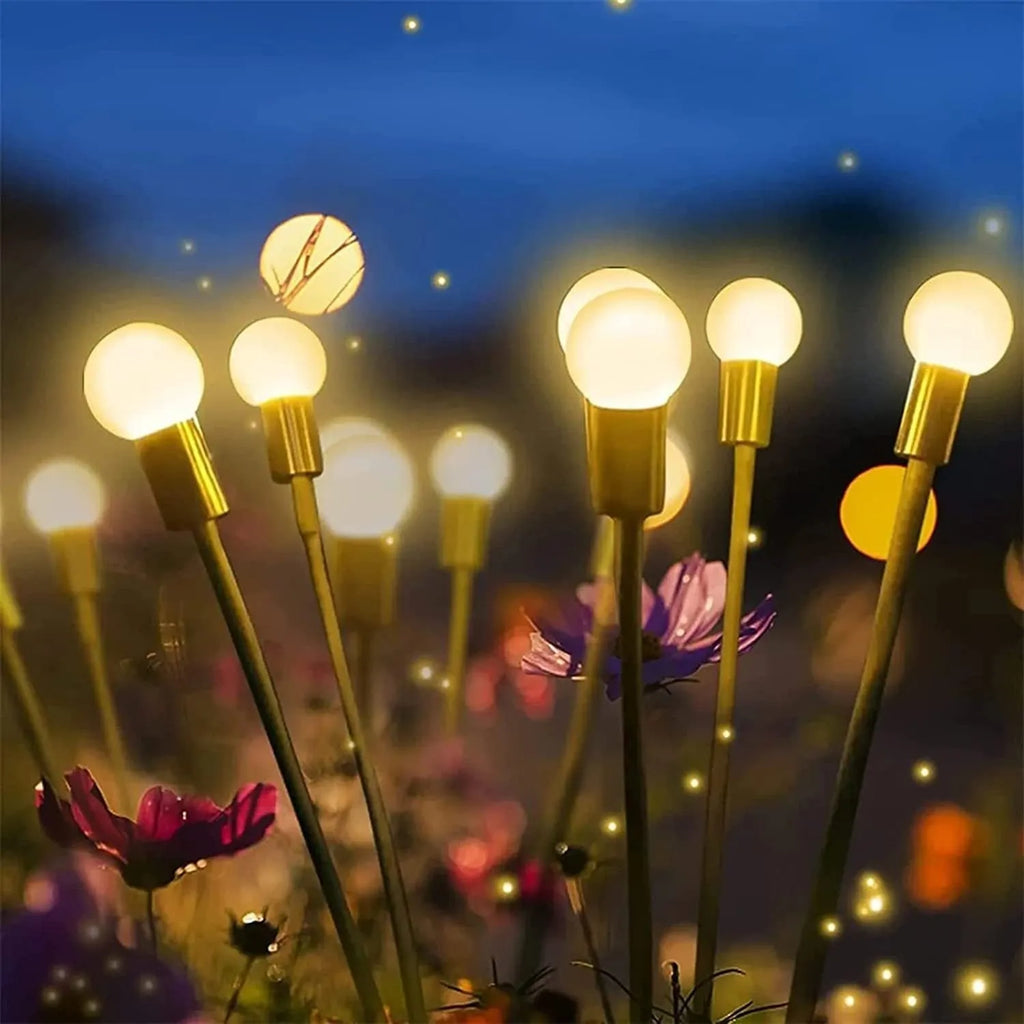 Solar-powered LED garden spike light with stainless steel ground plug stuck in soil.