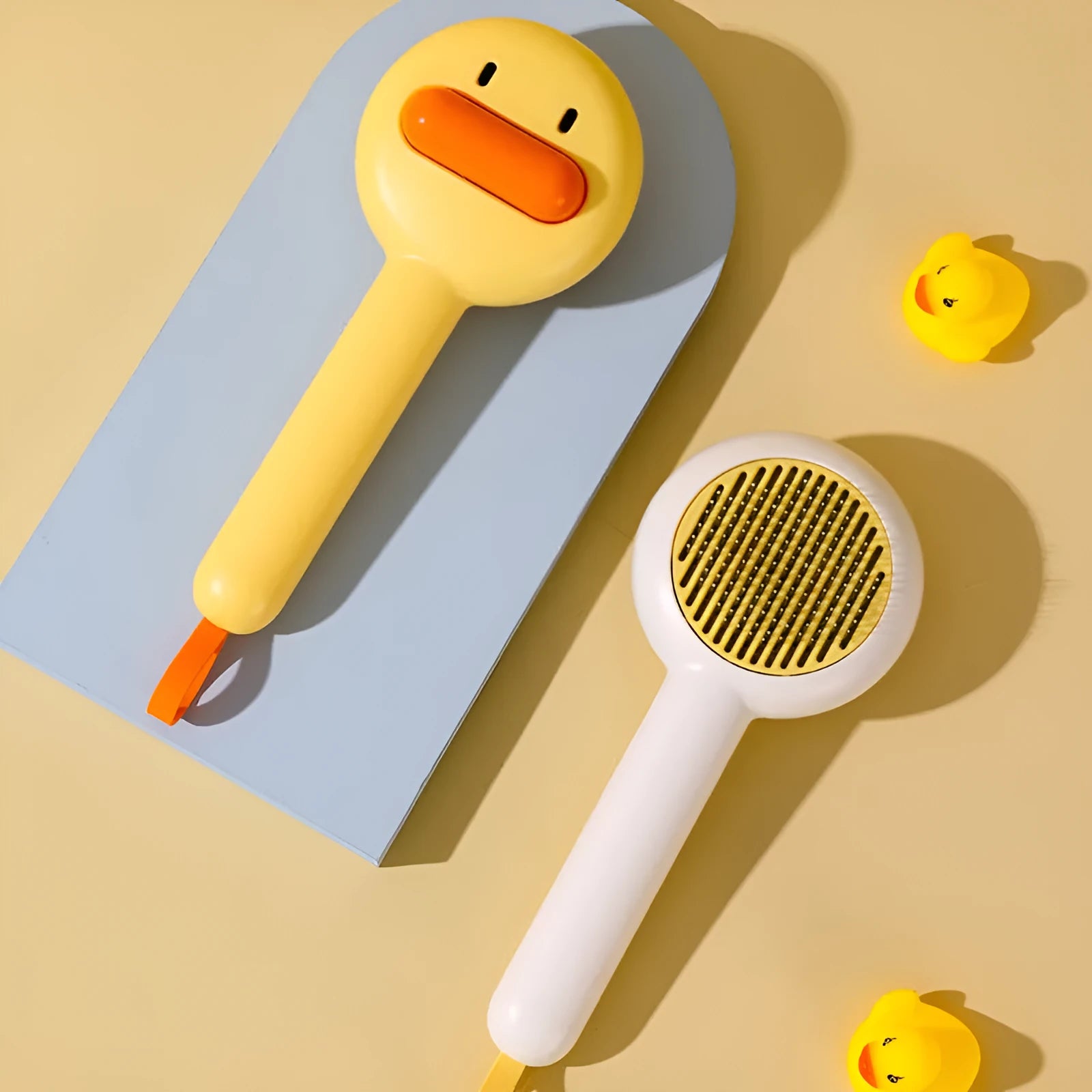 Small yellow cat grooming comb with needle teeth and floating hair removal device