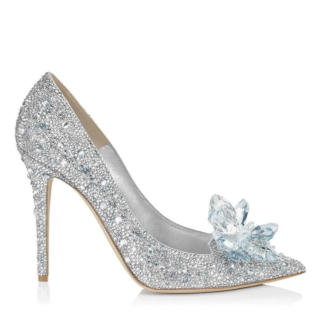 Women's gold pointed toe stiletto heels decorated with rhinestones and a bow