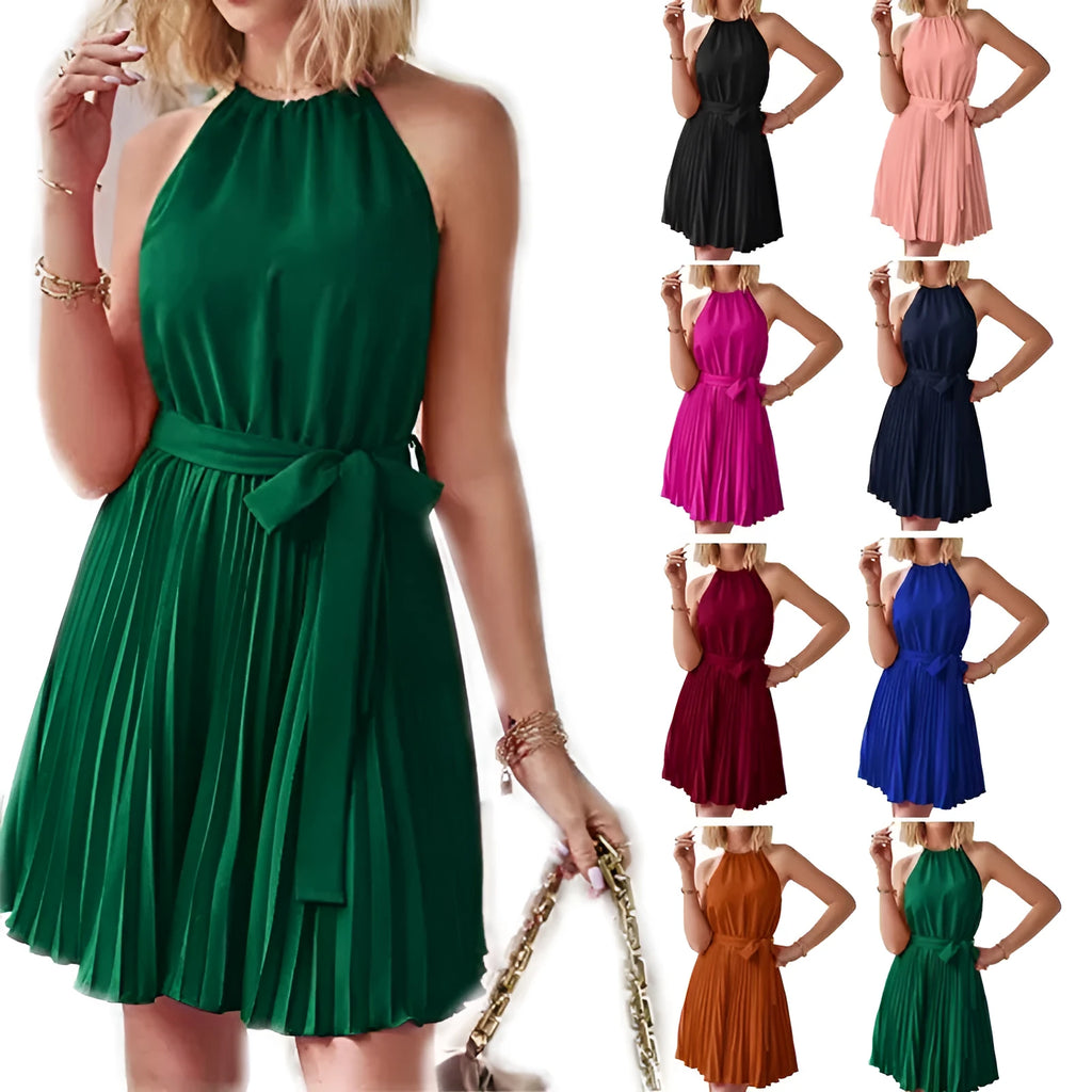 Woman wearing a black halter neck chiffon sundress with a pleated skirt and an adjustable waist tie.