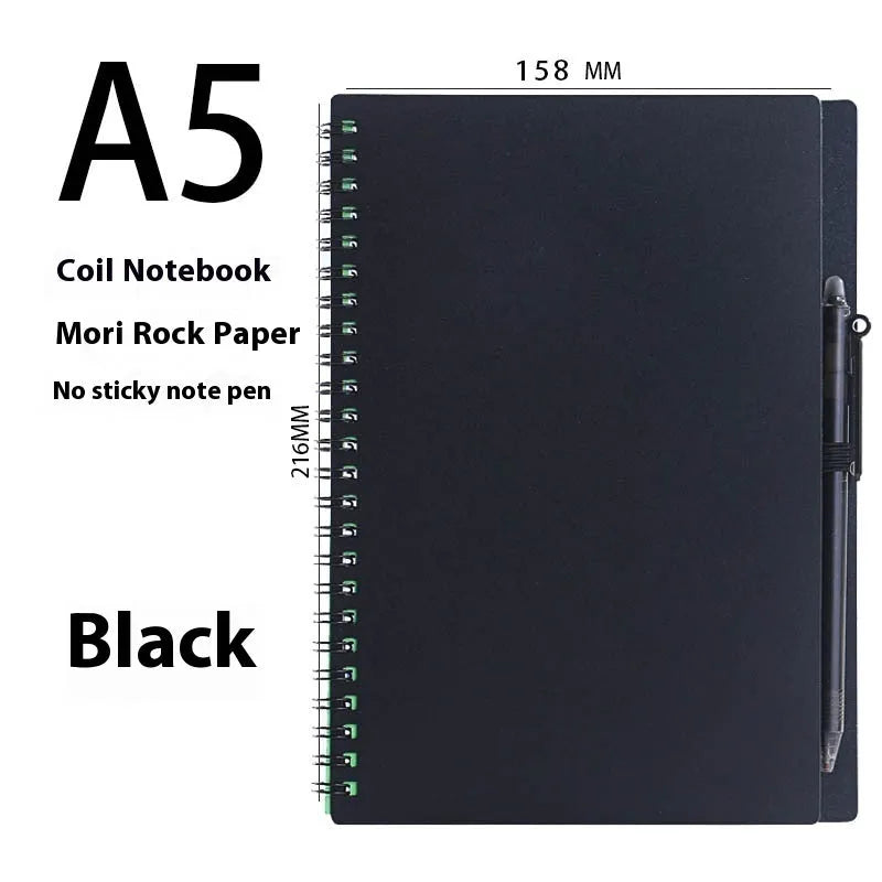 Erasable coil notebook with stone paper, showing a black cover option and a pen on a wooden desk.
